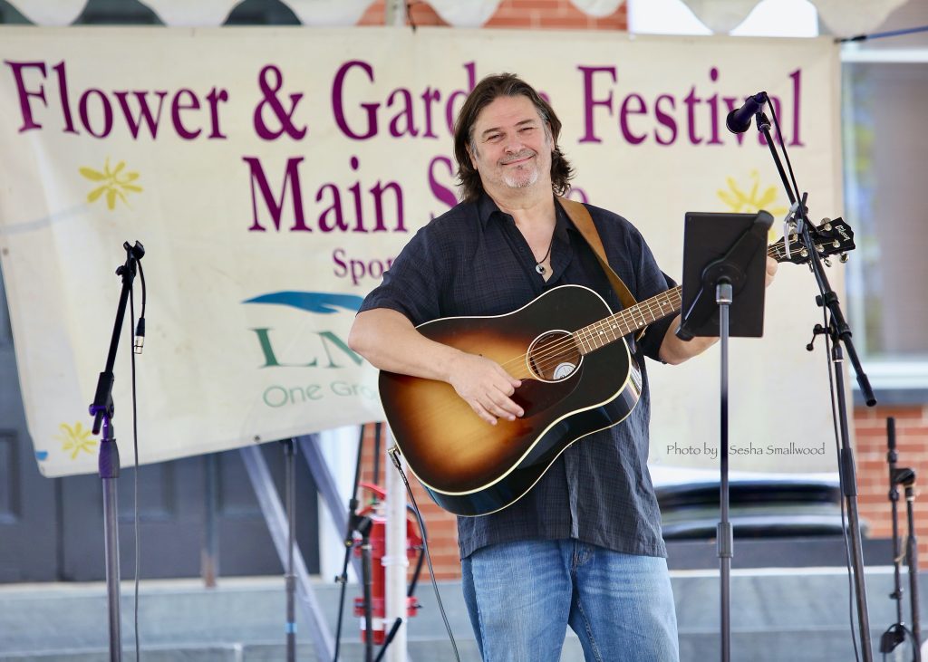Gary Smallwood with his guitar at the Flower & Garden Festival